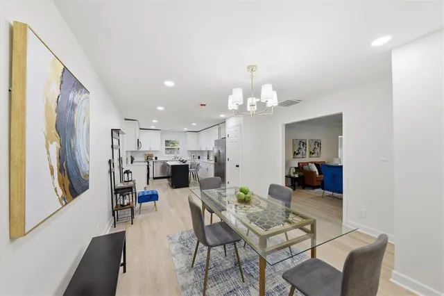 a view of a dining room with furniture and a chandelier