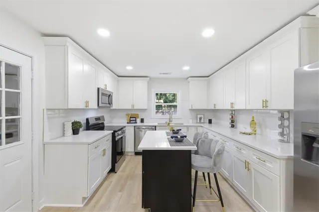a kitchen with a sink a stove cabinets and counter space