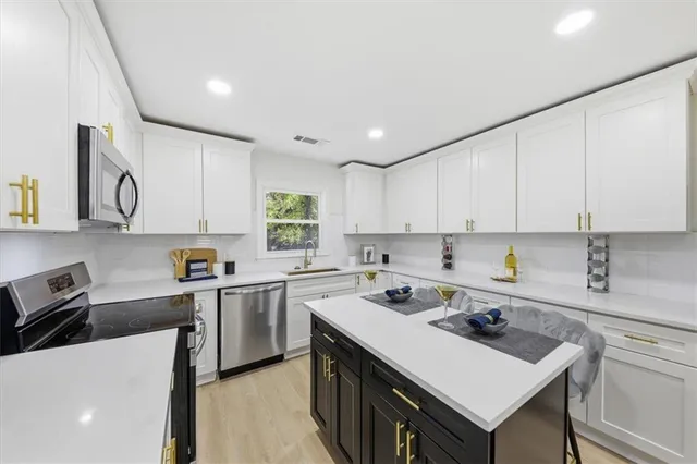 a kitchen with a sink a stove and cabinets