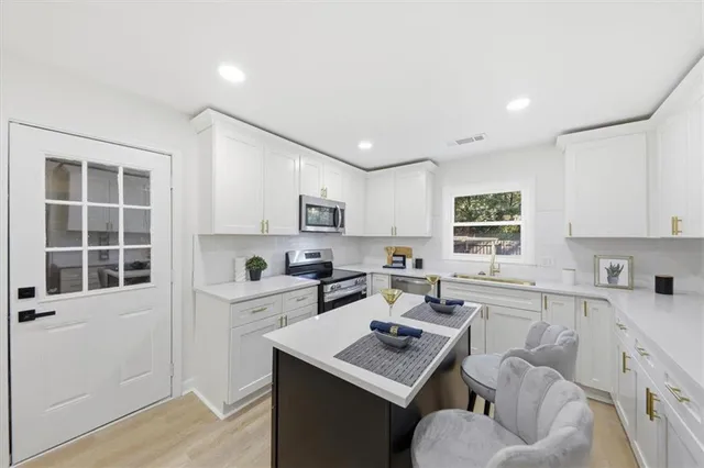 a kitchen with a sink cabinets and window