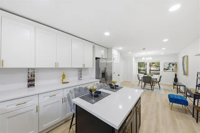 a kitchen with a sink cabinets and wooden floor