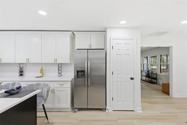 a kitchen with a refrigerator a sink and cabinets