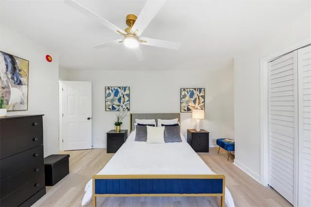 a bedroom with a bed and wooden floor