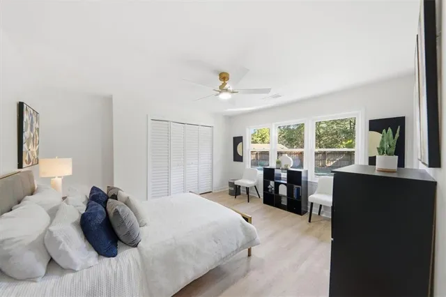 a bed room with a bed and a large window