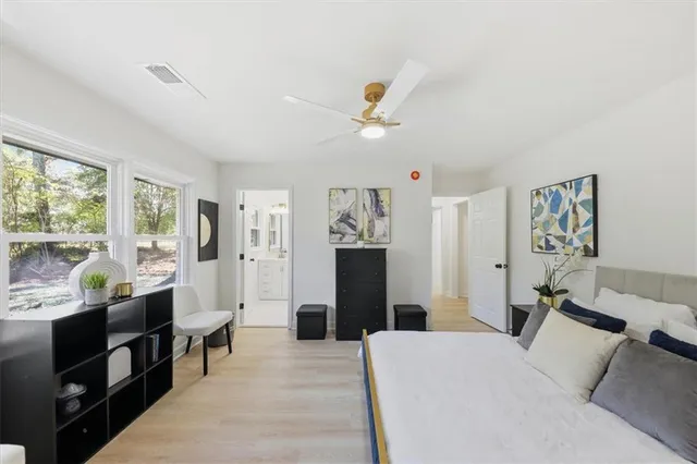 a living room with furniture a large window and a chandelier