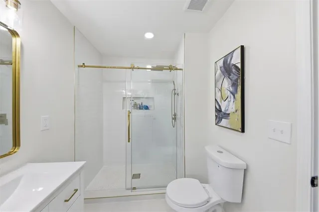 a bathroom with a toilet sink and shower