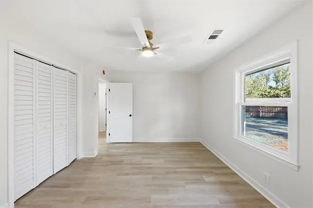 wooden floor in an empty room with a window