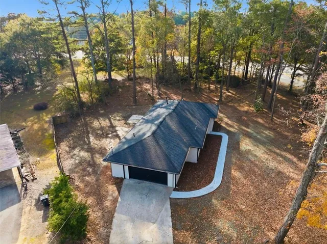 a view of a porch with chairs and wooden fence