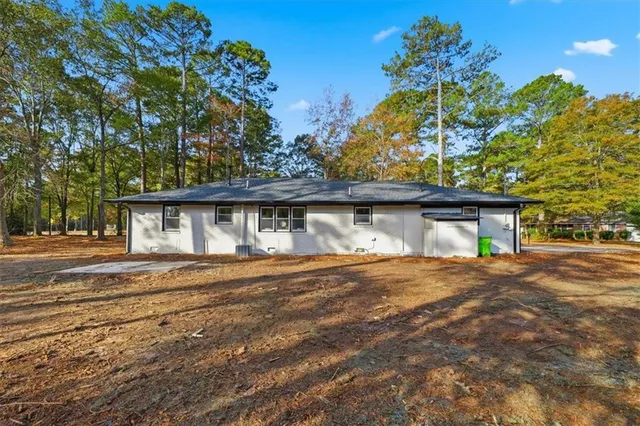 a view of a wooden house with a yard