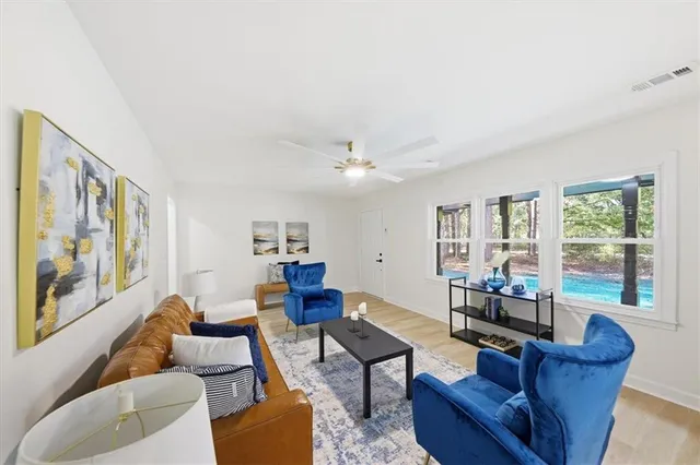 a living room with furniture and a large window