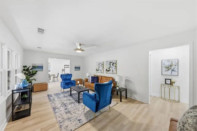a living room with furniture and wooden floor