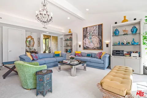 a living room with furniture and a floor to ceiling window