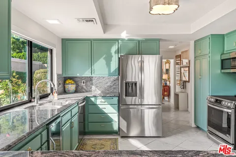 a kitchen with stainless steel appliances granite countertop a stove and a sink
