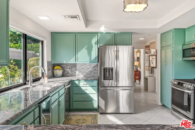 a kitchen with stainless steel appliances granite countertop a stove and a sink