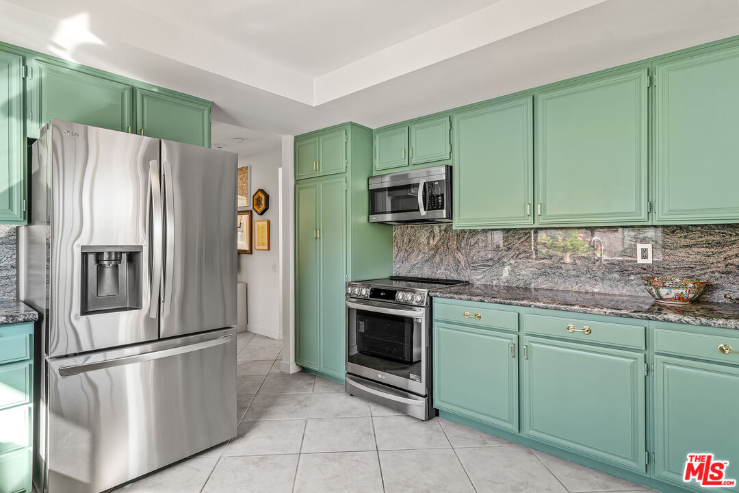72325 Roxbury Drive Rancho Mirage, CA 92270 - Photo 17 of 66 a kitchen with stainless steel appliances granite countertop a refrigerator sink and stove
