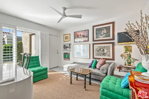 a bedroom with bed and a painting on the wall