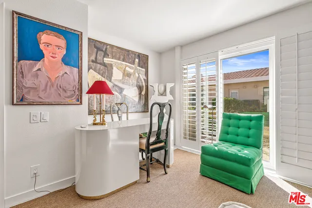 a spacious bedroom with a bed and a lamp