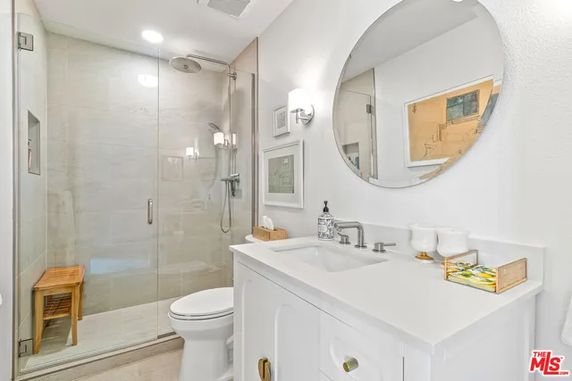 a spacious bathroom with double vanity sink a mirror and a shower