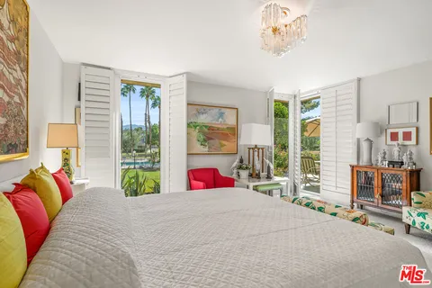 a view of a patio with a table and chairs under an umbrella
