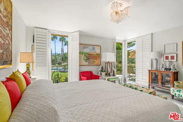 a view of a patio with a table and chairs under an umbrella