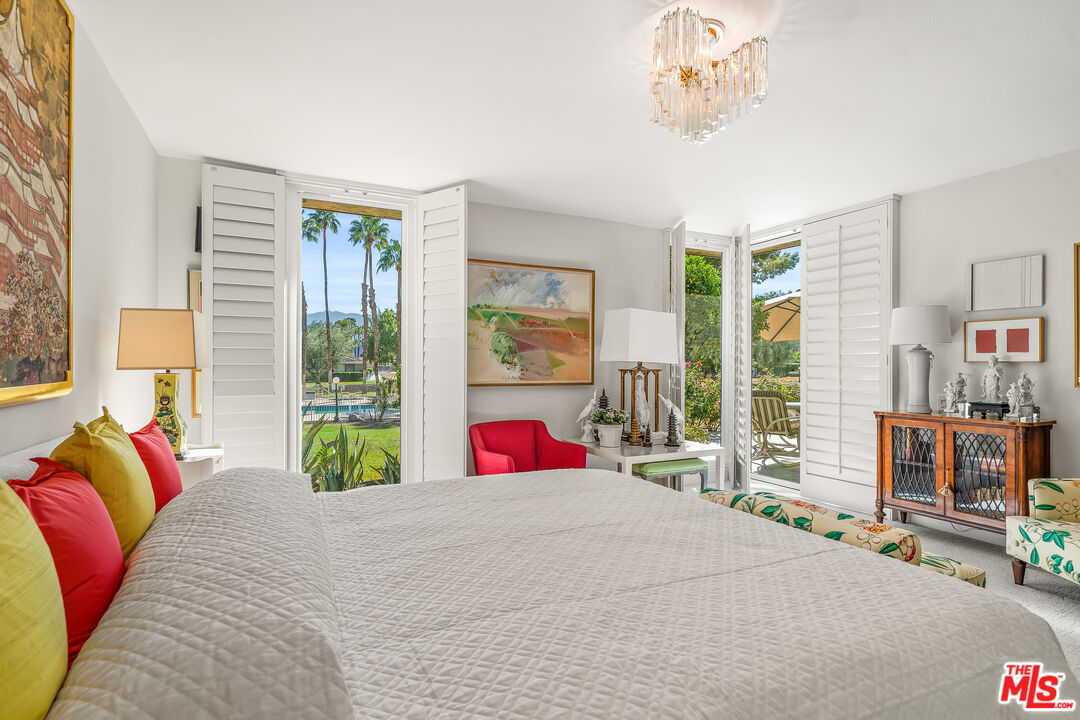 72325 Roxbury Drive Rancho Mirage, CA 92270 - Photo 29 of 66 a bedroom with a bed and glass windows