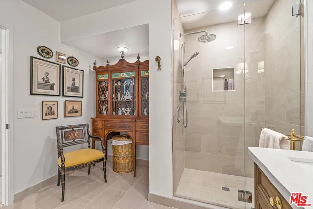 a view of a swimming pool with a lawn chairs and a large tree