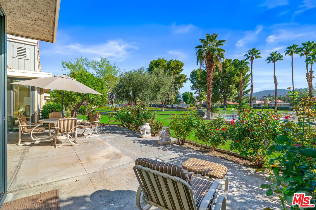 72325 Roxbury Drive Rancho Mirage, CA 92270 - Photo 36 of 66 a view of a patio with a table and chairs under an umbrella