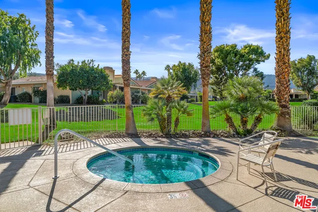 a view of a chairs and table in patio with a yard