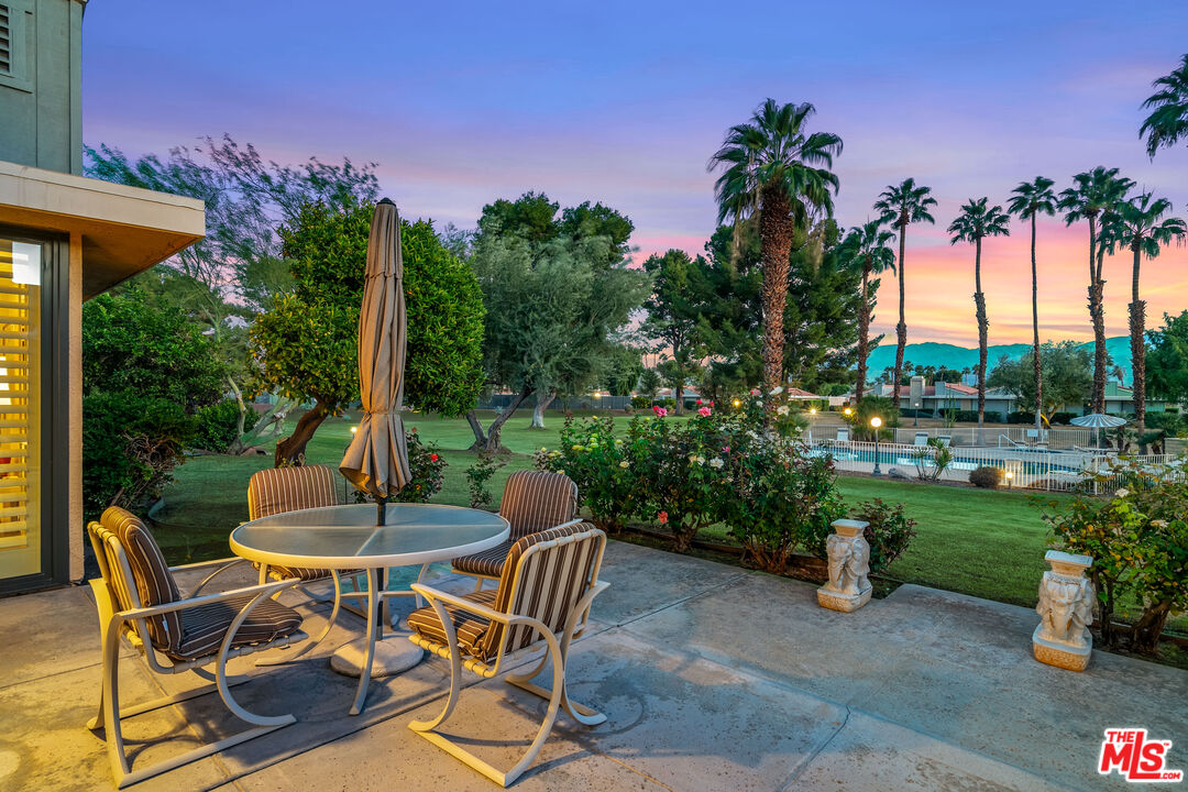 72325 Roxbury Drive Rancho Mirage, CA 92270 - Photo 52 of 66 a view of a chairs and table in patio with a yard