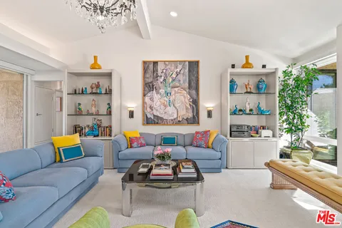 a living room with furniture flowerpot and window