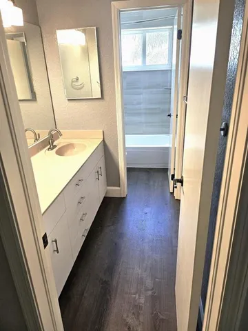 a bathroom with a sink a mirror and a shower