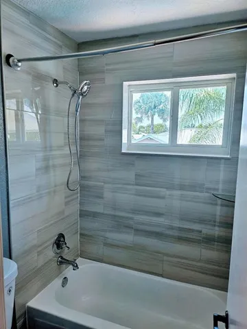 a bathroom with a shower and a bathtub