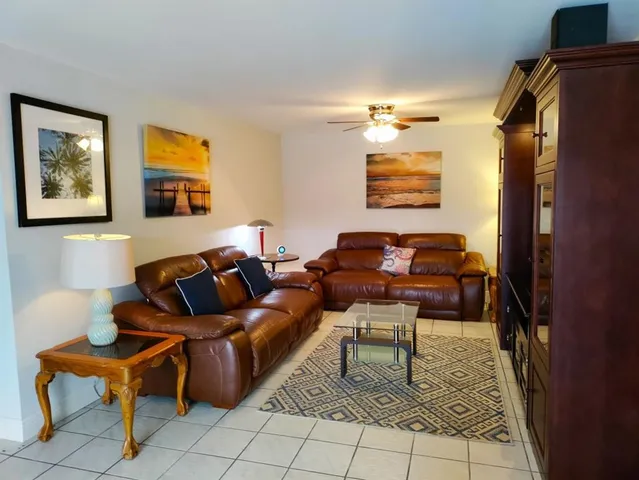 a living room with furniture and a rug