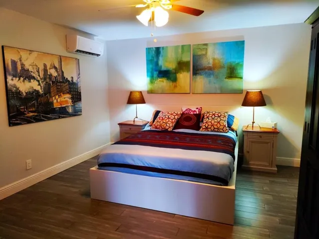 a bed room with furniture and painting on the wall