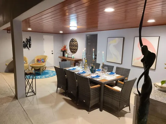 a living room with furniture and a mirror