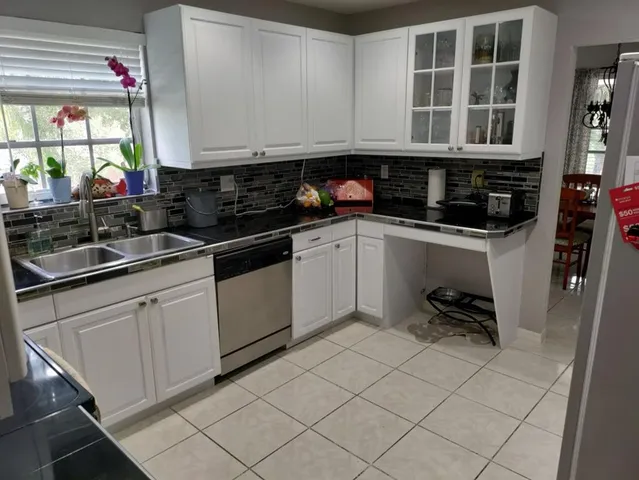 a kitchen with a sink a stove and cabinets