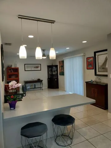 a kitchen with stainless steel appliances granite countertop a sink a stove a counter space and cabinets