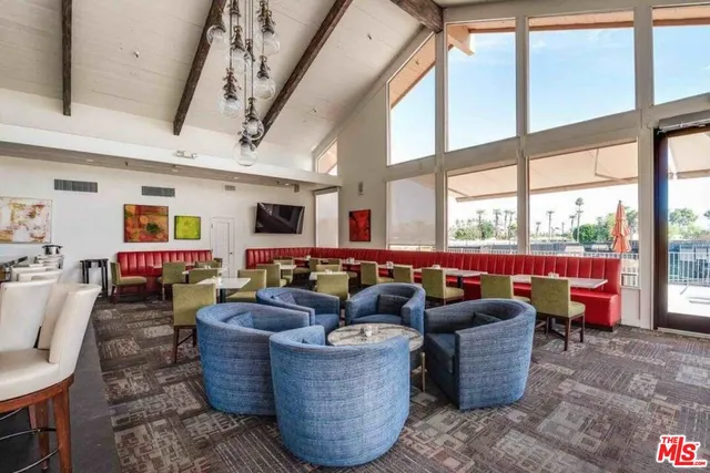 a living room with furniture a rug and a large window
