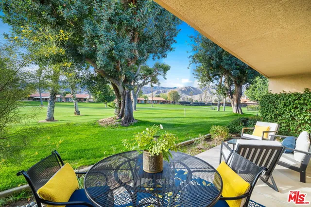 a view of a house with backyard sitting area and garden