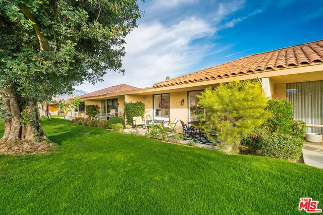 a view of a patio with table and chairs and potted plants
