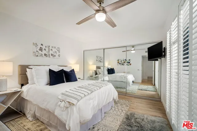 a bedroom with a large bed and a chandelier