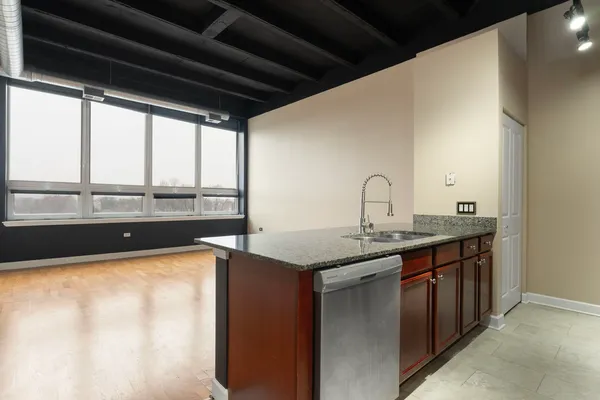 a kitchen with a sink and large window