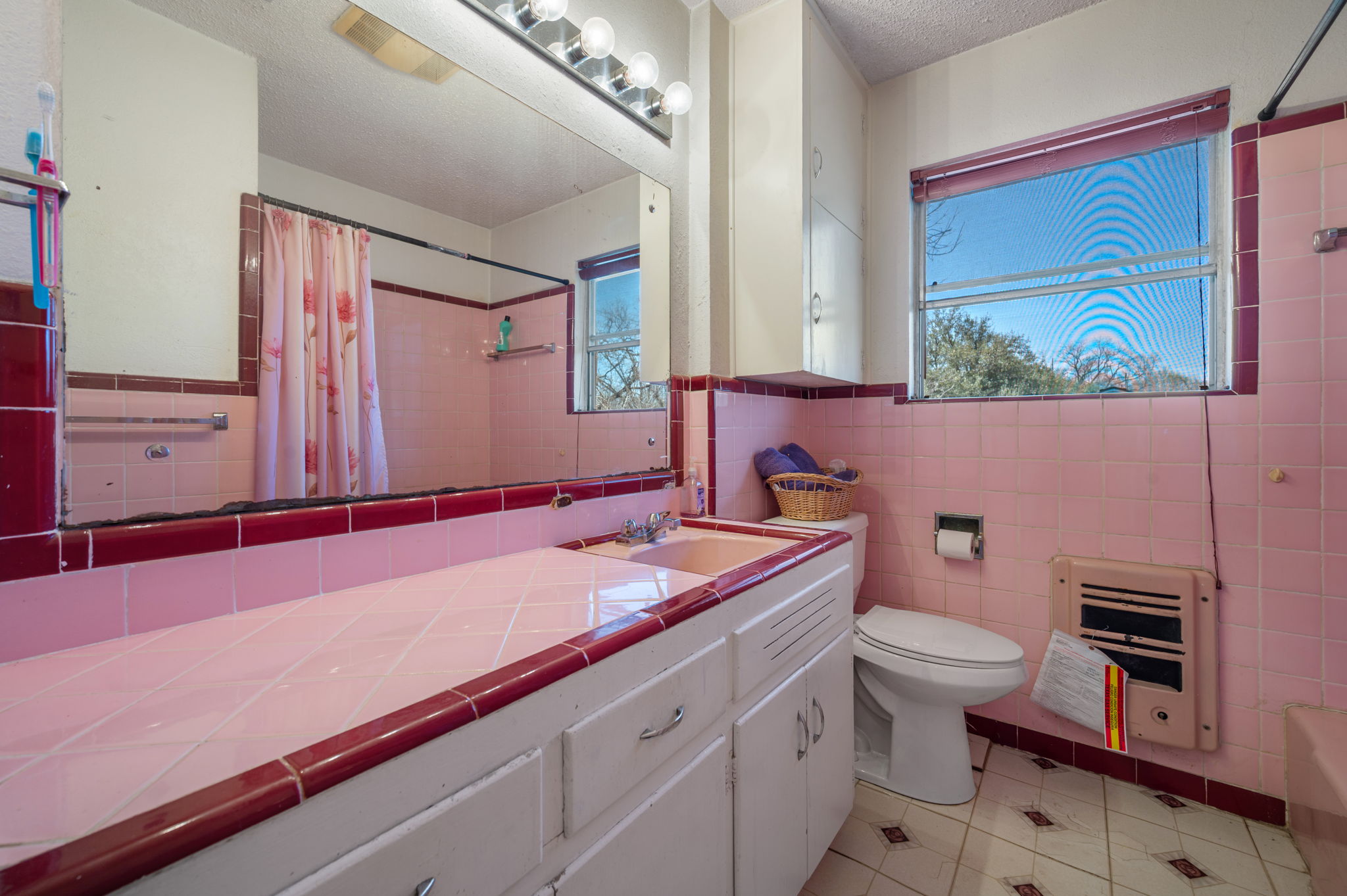 2000 Cedar Avenue Austin, TX 78722 - Photo 12 of 22 a bathroom with a sink a toilet and mirror