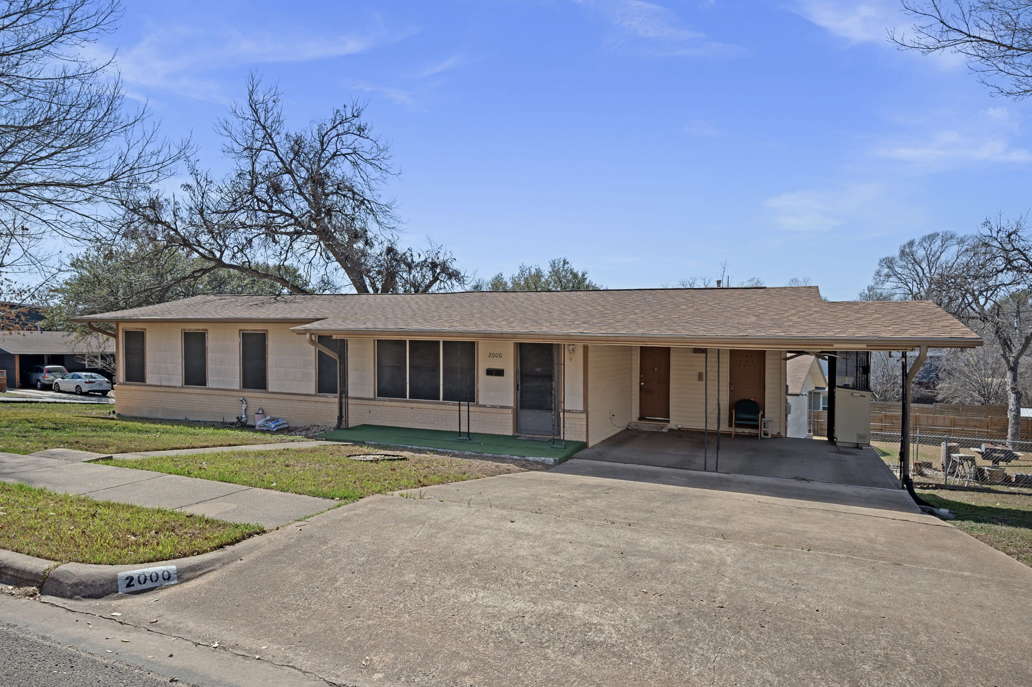 2000 Cedar Avenue Austin, TX 78722 - Photo 2 of 22 a front view of a house with a garden and trees