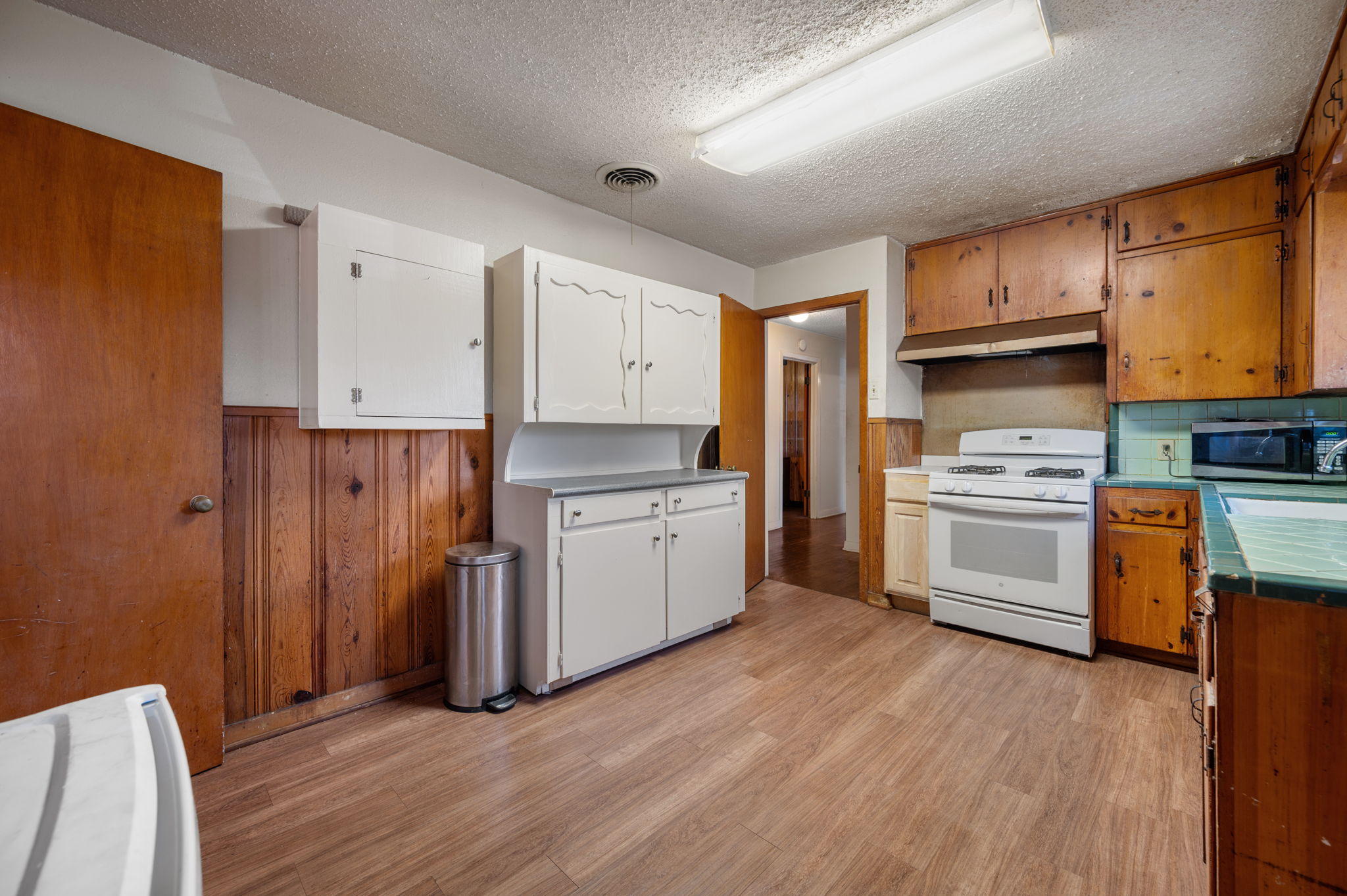 2000 Cedar Avenue Austin, TX 78722 - Photo 9 of 22 a kitchen with stainless steel appliances a stove top oven a refrigerator and cabinets