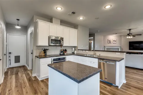 a kitchen with a sink stove and microwave