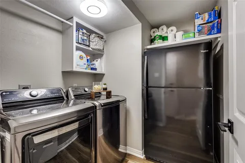 a kitchen with a refrigerator and a stove