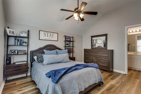 a bedroom with a large bed and a chandelier