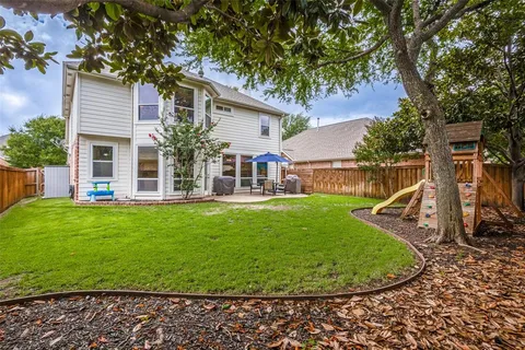 a view of a house with a backyard porch and sitting area