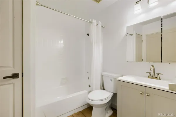 a bathroom with a sink toilet a mirror and shower